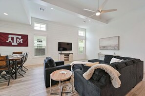 Enjoy the living area with the large sectional and smart tv.