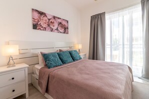 The master bedroom features a queen-size bed and an ensuite bathroom.