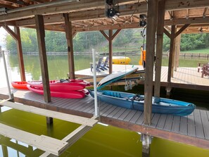 3 adult and 1 child kayaks along with 2 paddle boards