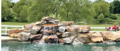 Enjoy the relaxing sound of your waterfall overlooking 14 private acres.