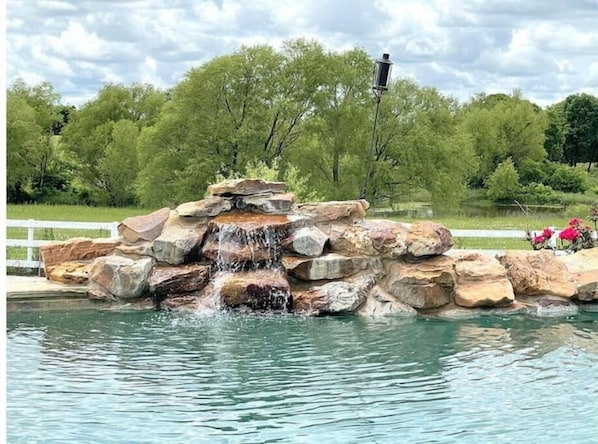 Enjoy the relaxing sound of your waterfall overlooking 14 private acres.