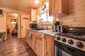 Fully stocked kitchen with all amenities :glasses, dishes, utencils, & microwave