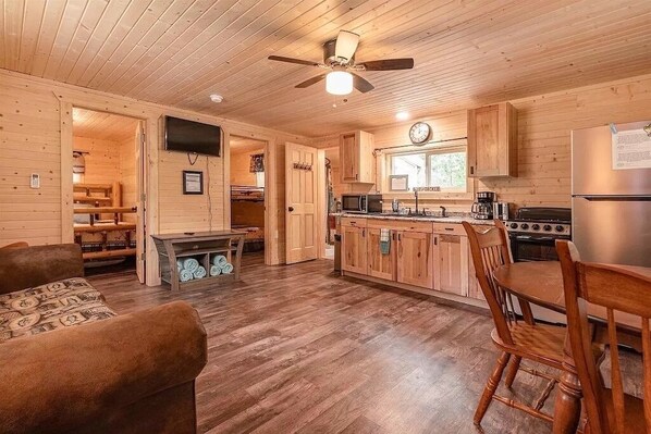 Spacious living room with full kitchen amenities. 