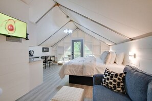 Spacious glamping tent featuring a private hot tub, king bed, and scenic views. Experience luxury camping in the heart of North Alabama.