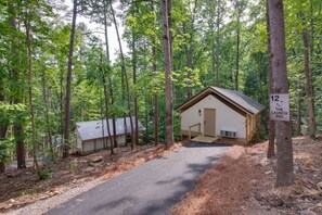 Spacious glamping tent featuring a private hot tub, king bed, and scenic views. Experience luxury camping in the heart of North Alabama.