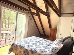 Upstairs bedroom #1 features a queen bed, sliding doors to upstairs deck