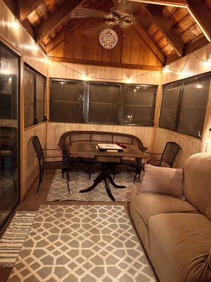 Screened in porch with ceiling fan is perfect for game night