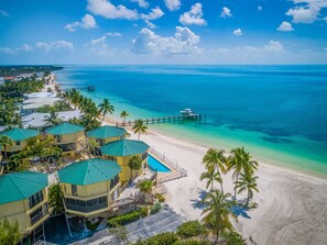 Close up aerial view of the heated pool and beachfront villas