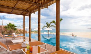 Covered pools chairs by swim up bar at beachside pool