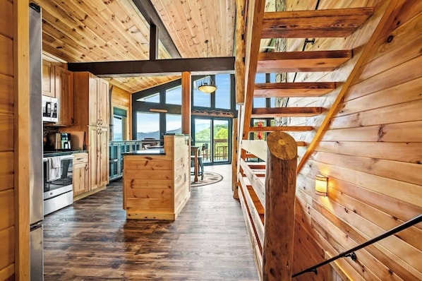 Open-floor layout w/ window wall.