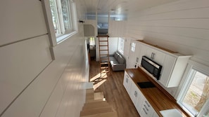Staircase connecting your living space to a fully equipped kitchen.