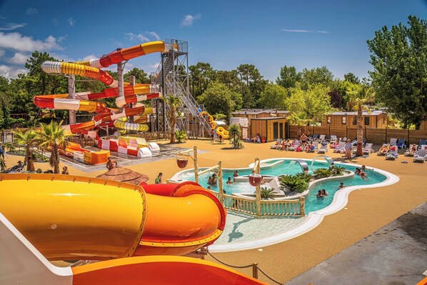 Vibrant pool area with multiple slides and splash features, offering fun for all ages.