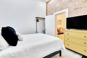 main bedroom-queen size bed with a smart tv