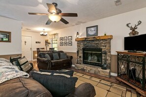 Living Room Features Couch, Loveseat, Flat Screen TV, and Wood Burning Fireplace