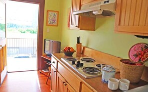 Kitchen in main living area with door to balcony
