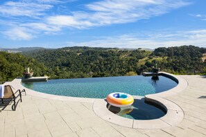 Private pool and hot tub in the backyard.