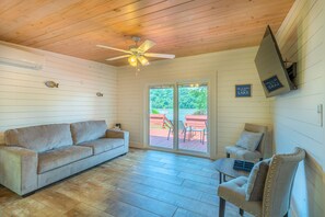 Living space with seating and views of Claytor Lake in the bungalow. 