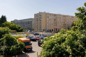 A pleasant city view of surrounding buildings and greenery, as seen from the apartment.
