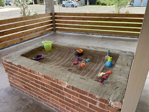The kids can play in the sandbox on the front porch!