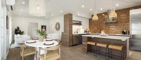 Open concept connect dining and kitchen with lofted ceilings throughout