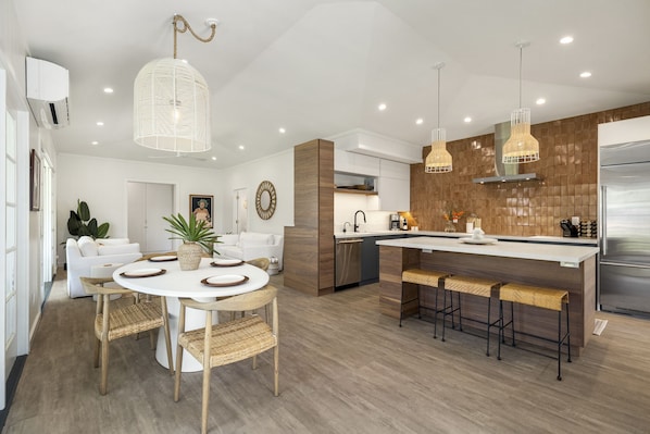 Open concept connect dining and kitchen with lofted ceilings throughout