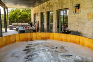 Experience pure bliss: Our cedar hot tub offers a soothing escape from the everyday hustle, immersing you in warmth and relaxation amidst nature's embrace.