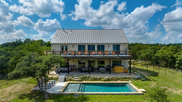 Relaxation at its finest: Soak up the sun on our tanning shelf, unwind in the cedar hot tub, and savor the stunning hill country views from our second-story deck. Welcome to paradise! 🌞🏞️ #HillCountryGetaway #PoolsideBliss