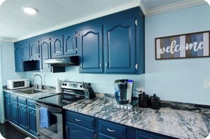 Well appointed kitchen with natural stone countertop. Plenty of pots, pans, utensils, basic spices and other essential appliances at your disposal. Cook a meal whilst enjoying the blue waters!
