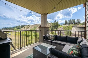 Private balcony with an outdoor sectional, BBQ, and lake views.