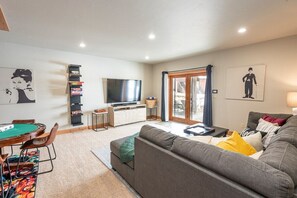 Spacious downstairs family room. 3-D TV,  xbox, poker table, and more! Step out the doors to enjoy our deck and hot tub area!