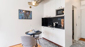 Kitchenette comes equipped with a stove, coffee machine, kettle and microwave for quick meals. #kitchen #cooking