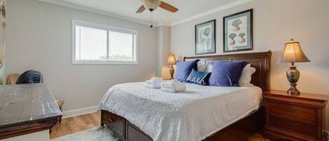 Spacious master bedroom with a king sized bed. 