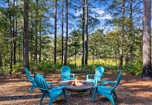 Warmth and woodland whispers meet at our cozy outdoor firepit.