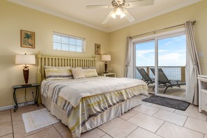 King sized bed in the main bedroom facing the gulf. Views of the beach and ocean directly from the large sliding glass door out to the patio