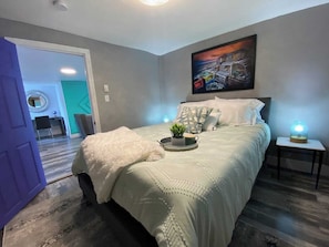 Enjoy a peaceful night's rest in the inviting bedroom, thoughtfully designed to provide a serene and restorative environment