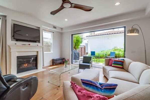 Spacious living room with sliding doors to open to the back yard and patio