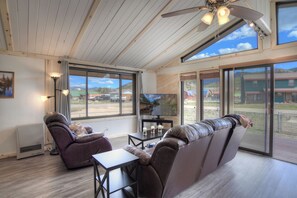 Main living space Warrick Cabin VRC Rental Home - Our living space features an Earth wood burning stove, sliding door to outdoor patio and smart TV.