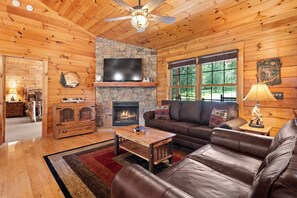 Living room with 55" Smart TV and gas fireplace operational during winter months