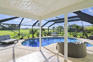 Pool area with sun loungers—relax in sun or shade by the sparkling pool.