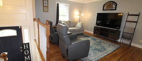 Living room with 2 recliners, loveseat, and smart TV