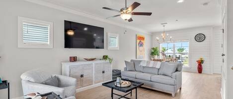 Living room space with brand new coastal furniture! Couch is has a queen pullout mattress.