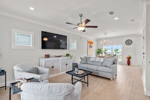 Living room space with brand new coastal furniture! Couch is has a queen pullout mattress.