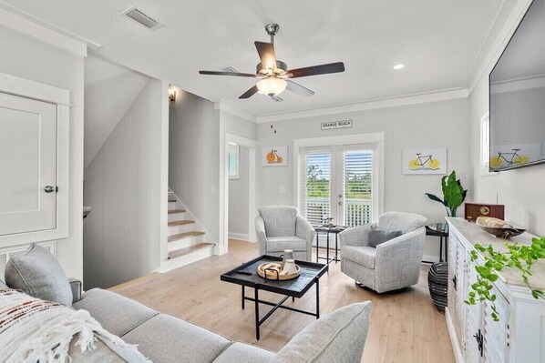 Living room space leading into upstairs bedrooms and living room access to full bathroom. 