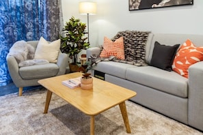 Elegant Living Area - Comfortable Couch, Cushions, Coffee Table and Decors