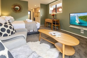 Room Amenities - Coffee Table, Dining Table, Widescreen Smart TV and Seating Area