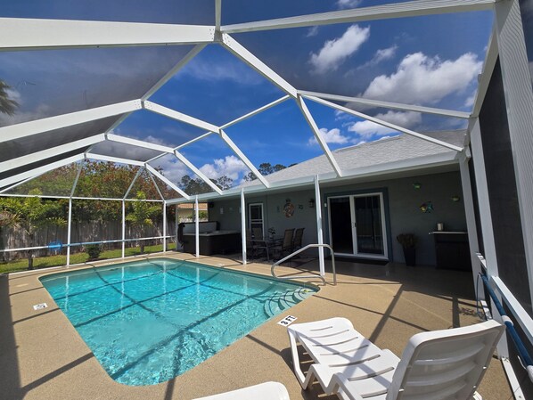 Pool / Hot tub and outdoor dining area, located inside screened lanai
