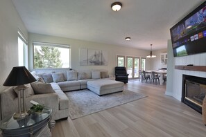 Family Room & Dining Room. Large flat screen TV, huge sectional couch, and fireplace.