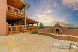 Spectacular outdoor fireplace (firewood is NOT provided) and seating area on the first level located by the garage. The views are utterly amazing!