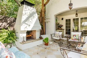 Outdoor seating and fireplace with french doors to Living room