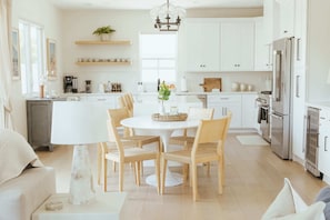 An inviting space where meals turn into cherished memories. Our beautifully designed dining room seamlessly blends into a modern, fully-equipped kitchen, perfect for cooking up delicious experiences.